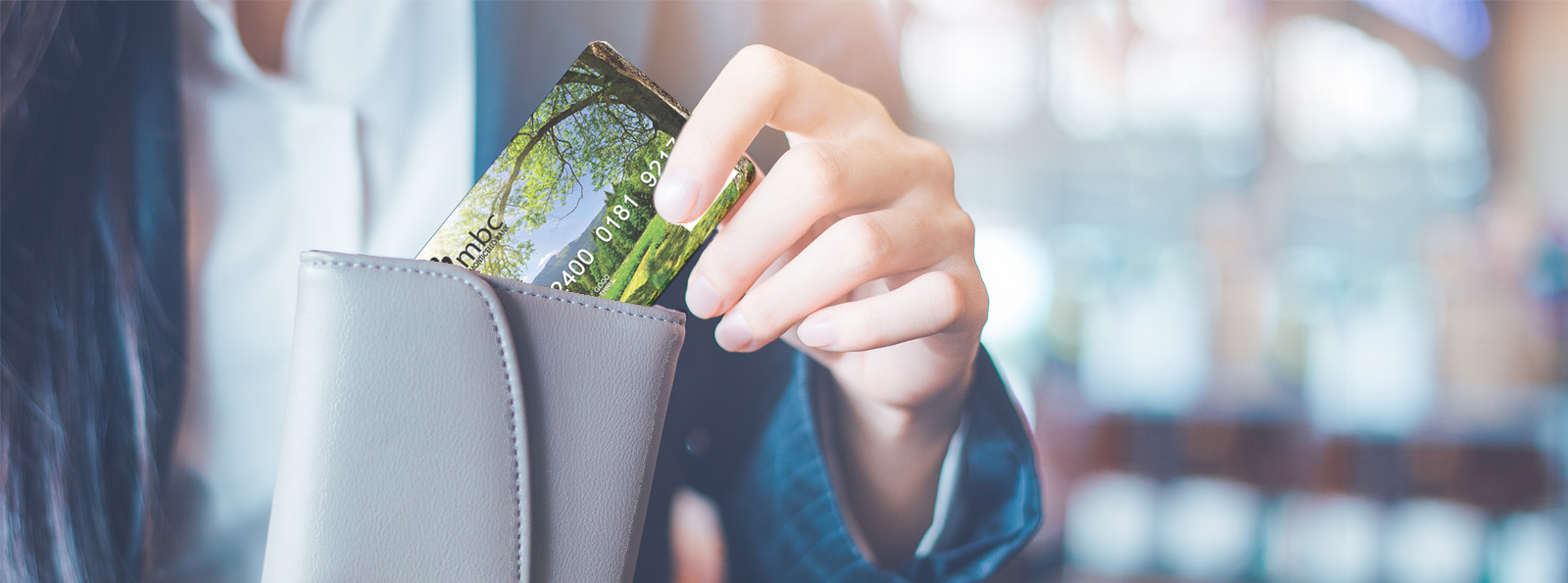 customer pulling Swift Stellar Debit Card from their wallet